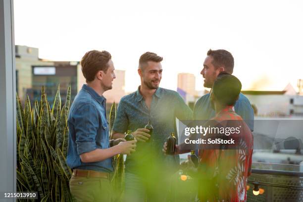 beer with the boys - rooftop deck stock pictures, royalty-free photos & images