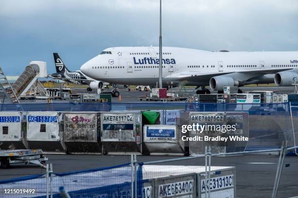 An Air New Zealand domestic flight passes behind the Lufthansa Boeing 747-400 which arrived at 7am at Auckland International Airport to pick up...