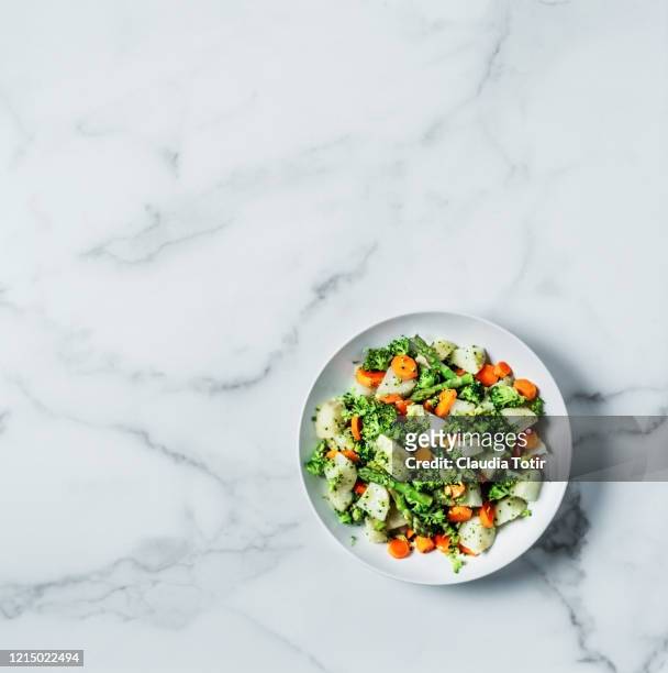 potato salad with asparagus, carrots and broccoli on white, marble background - salad bowl stock pictures, royalty-free photos & images