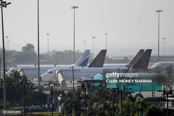 Airport staff arrive at the Indira Gandhi International airport during the first day of resuming of domestic flights after the government imposed a...