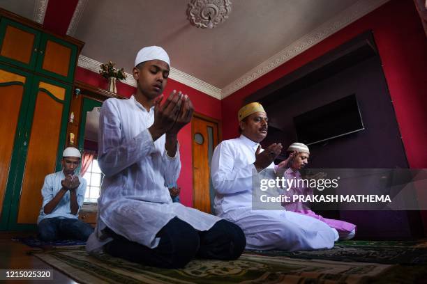 Muslim family offers a special prayer in their home during the Eid-al-Fitr festival, which marks the end of Islamic holy fasting month of Ramadan, in...