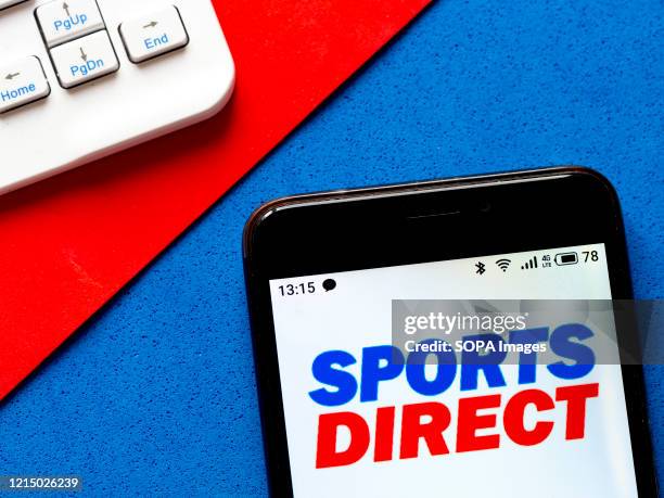 In this photo illustration a Sports Direct logo seen displayed on a smartphone.