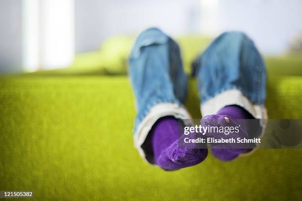 boy's feet with socks - couch potato stock-fotos und bilder