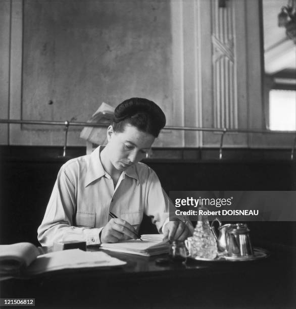 Paris, French author and philosopher Simone De Beauvoir at the Deux Magots cafe, Saint-Germain-Des-Pres