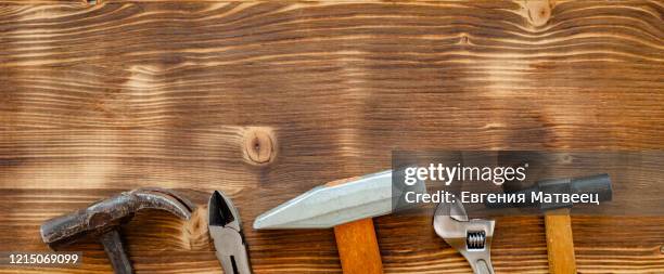 old repair tools claw hammer pliers, spanner on brown color wooden background. labor day concept - may day in russia photos et images de collection