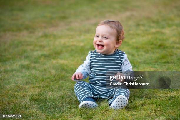 baby boy 10 months old with toothy smile - toddler boys stock pictures, royalty-free photos & images