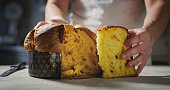 chef who controls the quality of his Italian panettone by touching it with his hand to understand the softness.