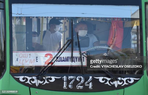Bus driver wearing a face mask is at work in Bishkek, on May 25 on the reopening day for public transports as the country eases lockdown measures...