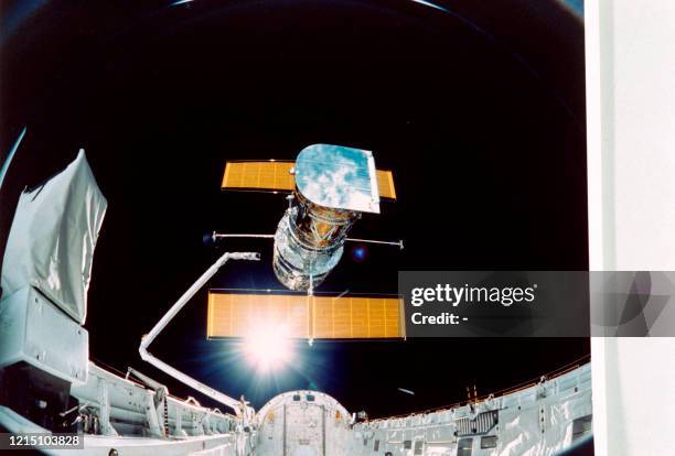 Picture taken by the STS-31 crew aboard the Space Shuttle Discovery showing the Hubble Space Telescope being deployed on April 25, 1990 from the...