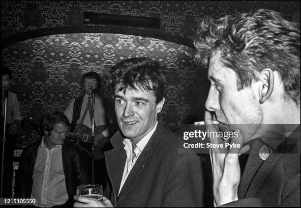 British tin whistle player and singer Spider Stacy and British singer-songwriter Shane MacGowan drinking in The Crown pub, a band playing on the...