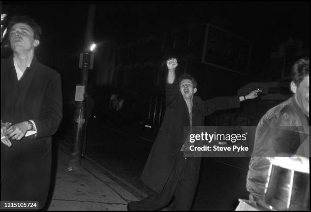 British tin whistle player and singer Spider Stacy and British singer-songwriter Shane MacGowan on Cricklewood Broadway in London, England, 1984. The...