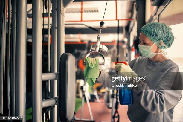 woman disinfecting and cleaning gym - health club covid stock pictures, royalty-free photos & images