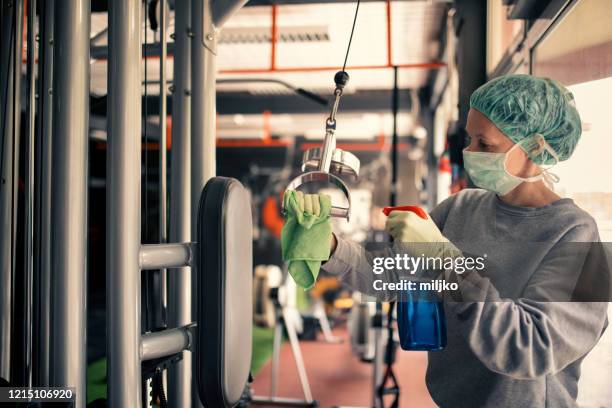 woman disinfecting and cleaning gym - gym covid stock pictures, royalty-free photos & images