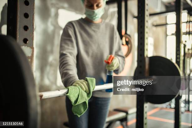 woman disinfecting and cleaning gym - health club covid stock pictures, royalty-free photos & images