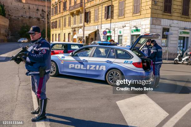 some officers of the italian police patrol a street in the prati district in the historic center of rome - spartan cruiser stock pictures, royalty-free photos & images