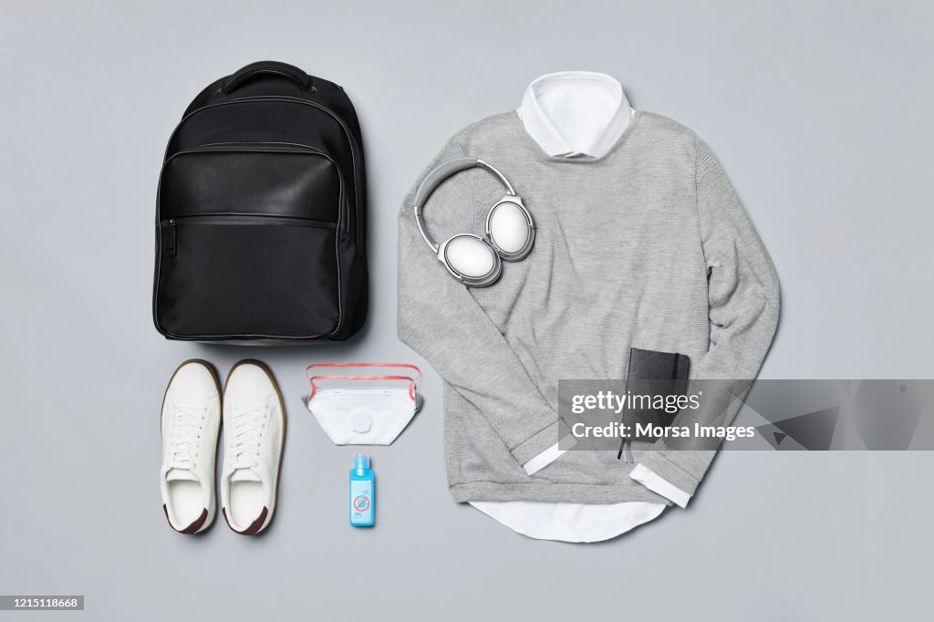 Flat lay of menswear with personal accessories against covid-19.