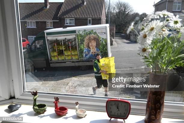 Morrisons supermarket delivery van delivers to a house on March 27, 2020 in Weymouth, United Kingdom. The UK's supermarkets have been struggling to...