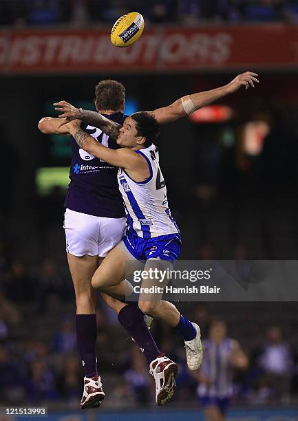 Aaron Edwards of the Kangaroos contests with Aaron Sandilands of the Dockers during the round 22 AFL match between the North Melbourne Kangaroos and...