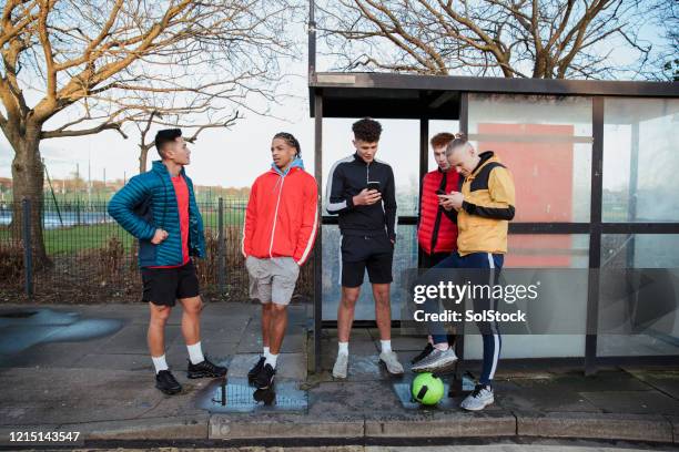 waiting for the bus - bus stop uk stock pictures, royalty-free photos & images