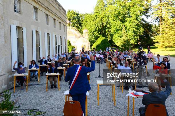 Mayor of Gradignan Michel Labardin holds a vote during a municipal council meeting on his reelection and of his deputies, at Parc Laurenzanne in...