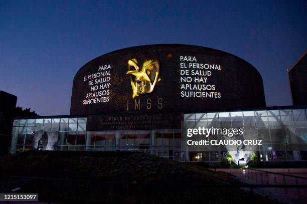 Lights and messages are projected onto the Mexican Institute of Social Security building in Mexico City on May 25, 2020. - The Mexican Institute of...