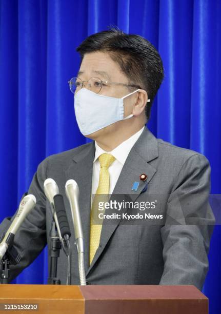 Japanese health minister Katsunobu Kato speaks at a press conference in Tokyo on May 26 about Fujifilm Holdings Corp's anti-influenza drug Avigan....
