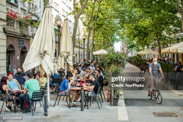 Several customers taking a drink at the tables of a restaurant terrace at Barceloneta beach de Barcelona when Barcelona begins Phase 1 which allows...