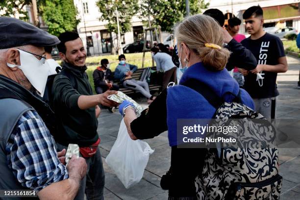 Volunteer group of citizens provid masks to some migrants to prevent the spread of the Coronavirus outside the train station of the city of Trieste....