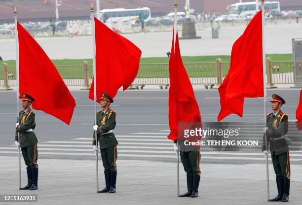 An Chinese honor guard is covered by a flag during a welcoming ceremony for visiting Spanish King Juan Carlos I, at the Great Hall of the People in...