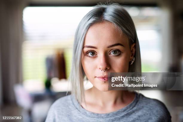 front view portrait of young woman at home. - earring stud stock pictures, royalty-free photos & images