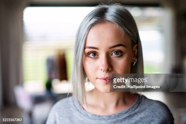 front view portrait of young woman at home. - nose piercing - fotografias e filmes do acervo