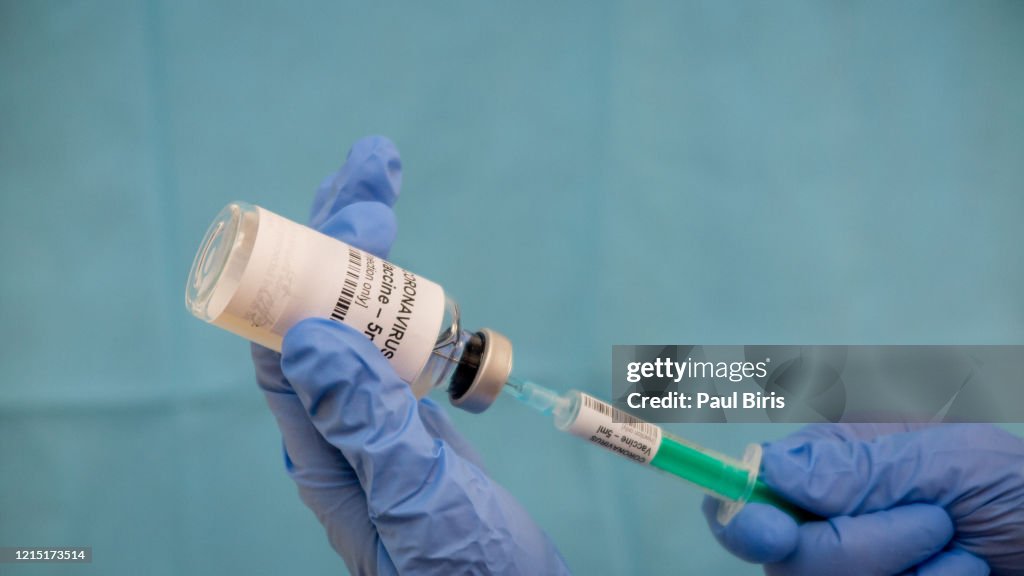 Infectious doctor fills injection syringe with CO-VID 19 vaccine - concept,  for prevention, immunization and treatment  for new corona virus infection(COVID-19,novel coronavirus disease 2019)