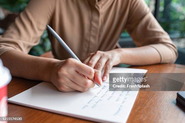 planning ahead: cropped shot of an anonymous woman's hands writing notes in a notebook - poet stock pictures, royalty-free photos & images