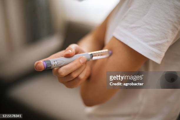 woman doing insulin injection - insulin stock pictures, royalty-free photos & images