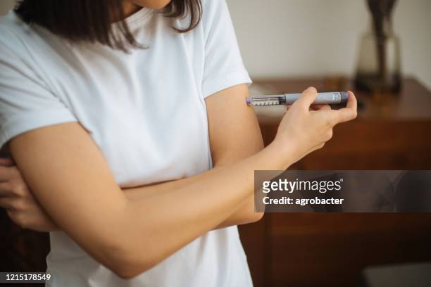 woman doing insulin injection - german mark note stock pictures, royalty-free photos & images