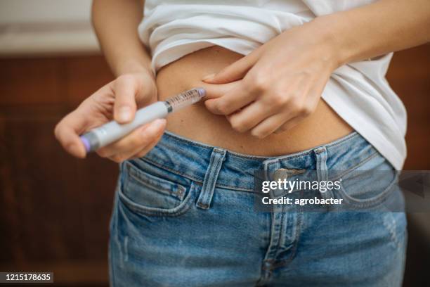 woman doing insulin injection - german mark note stock pictures, royalty-free photos & images