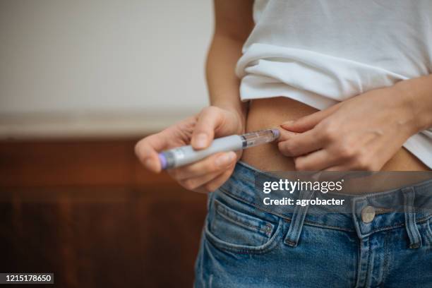 woman doing insulin injection - german mark note stock pictures, royalty-free photos & images