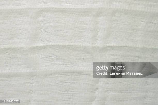 white color woven cotton gauze fabric background texture. close up top view. - gauze stock-fotos und bilder