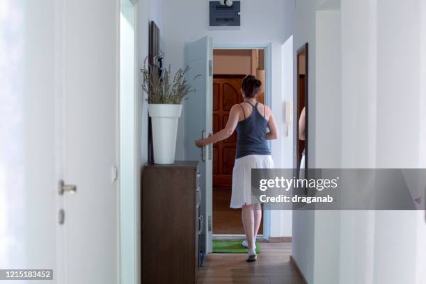 woman going out - landing home interior stock pictures, royalty-free photos & images