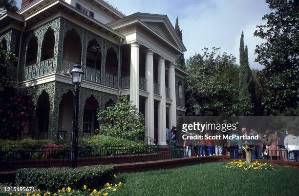 View of park goers waiting in line to enter the Haunted Mansion attraction at Disneyland, Anaheim, California, February 1980.