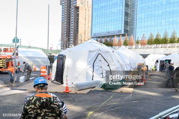 Workers build a makeshift morgue outside of Bellevue Hospital to handle an expected surge in coronavirus victims on March 27, 2020 in New York City....