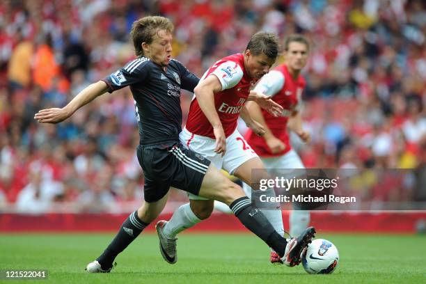 Leiva Lucas of Liverpool tackles Andrey Arshavin of Arsenal during the Barclays Premier League match between Arsenal and Liverpool at the Emirates...