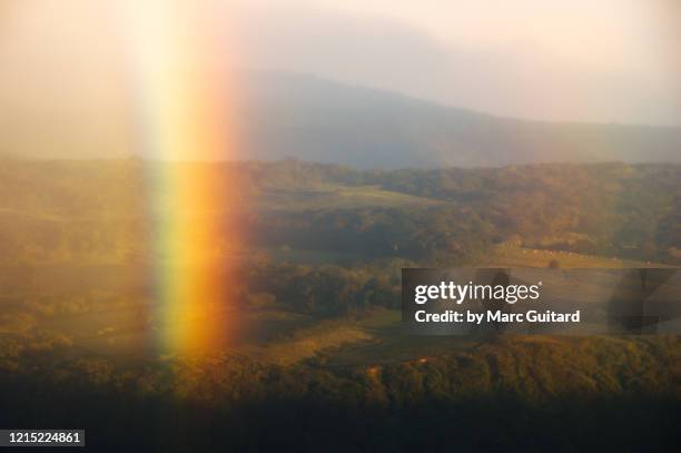 stunning rainbow over the countryside near monteverde, costa rica - モンテベルデ雲林保護区 ストックフォトと画像