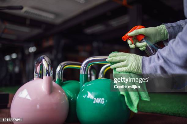 woman disinfecting and cleaning gym - health club covid stock pictures, royalty-free photos & images