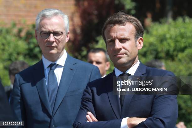 French President Emmanuel Macron arrives with French Economy Minister Bruno Le Maire to visit a factory of manufacturer Valeo in Etaples, near Le...