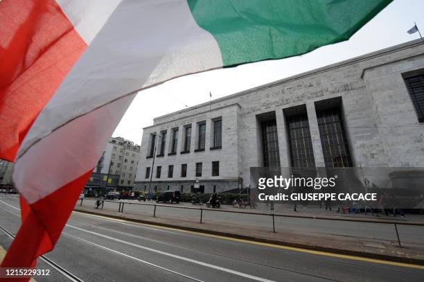 An Italian flag is displayed in front of Milan justice court on April 4, 2011. Italian Prime Minister Silvio Berlusconi was absent the same day from...