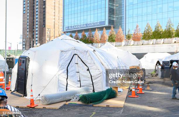 Workers build a makeshift morgue outside of Bellevue Hospital to handle an expected surge in coronavirus victims on March 27, 2020 in New York City....