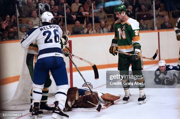 Steve Payne of the Minnesota North Stars skates against Barry Melrose and Mike Palmateer of the Toronto Maple Leafs during NHL playoff game action on...