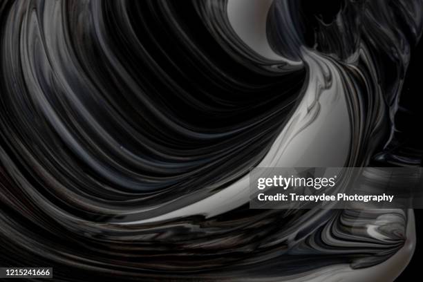 black and white paint swirl - black and white paint mix stock pictures, royalty-free photos & images