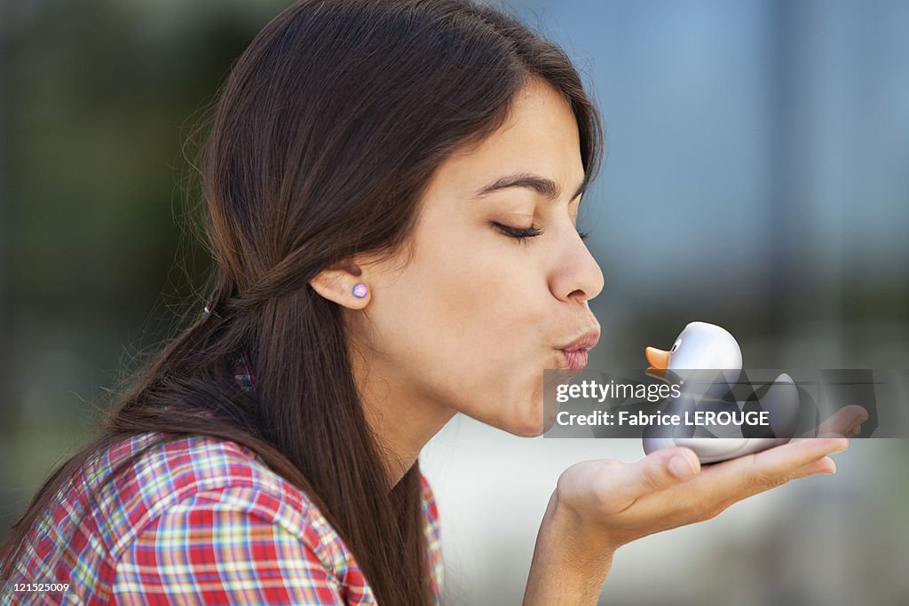 Woman kissing rubber duck